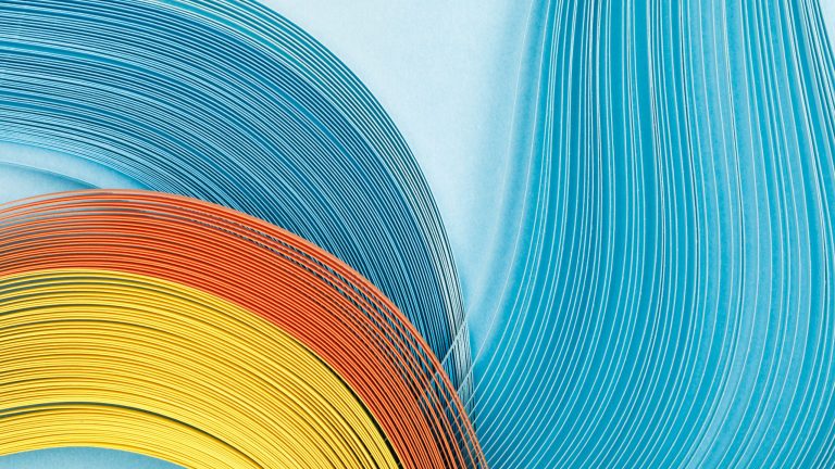 top view of multicolored bright abstract lines on blue background